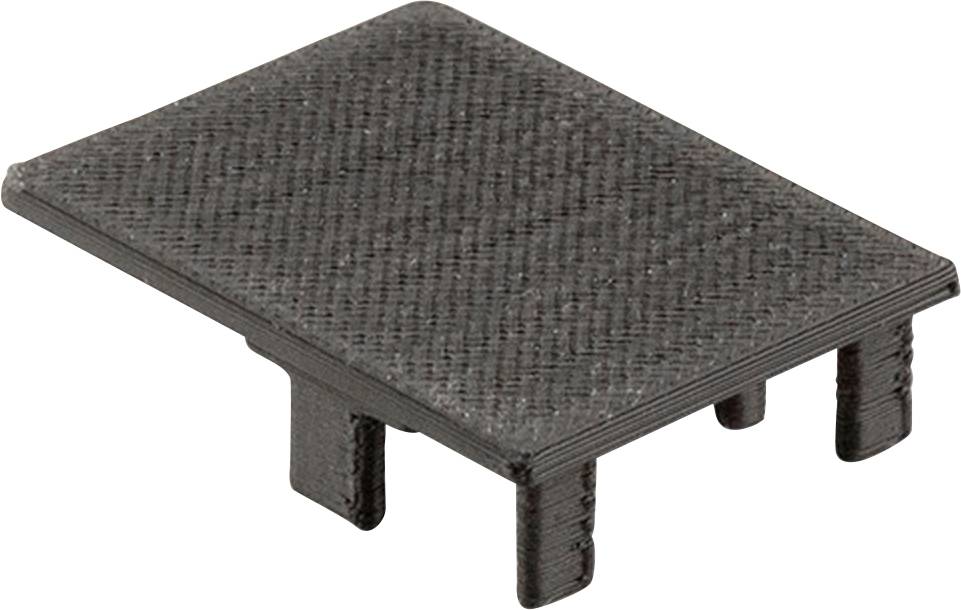 Prostokątny, czarny element maskujący wykonany z tworzywa sztucznego o strukturyzowanej powierzchni, wyposażony w trzy podpórki od spodu.