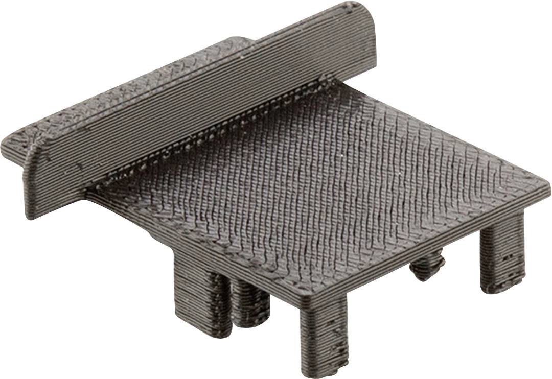 Czarny, prostokątny element z podwyższoną krawędzią po jednej stronie i czterema krótkimi nogami. Możliwe zastosowanie w maszynach lub elektronice.