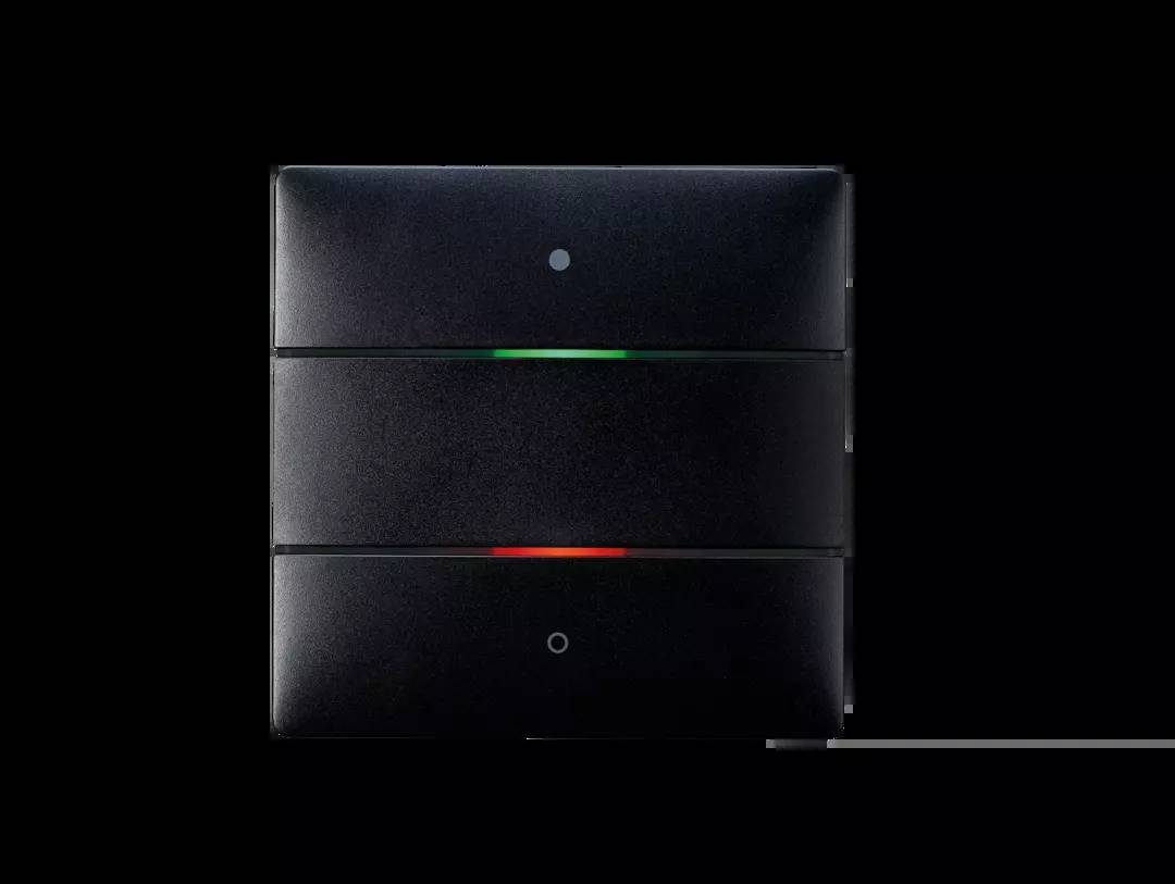 Przełącznik z czarną ramką z dwoma przyciskami; górny z zielonym światłem, dolny z czerwonym światłem, na ciemnym tle.