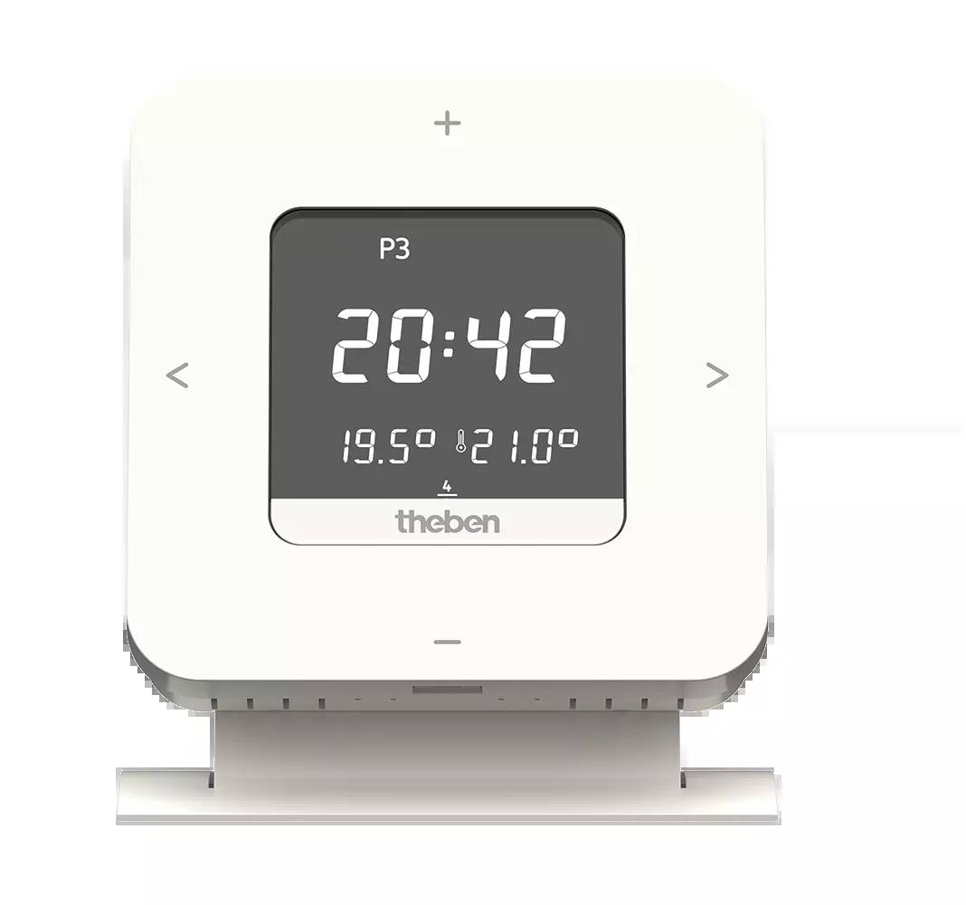 Cyfrowy termostat z wyświetlaczem pokazującym godzinę '20:42', aktualną temperaturę '19,5°' oraz temperaturę docelową '21,0°'. Marka: Theben.
