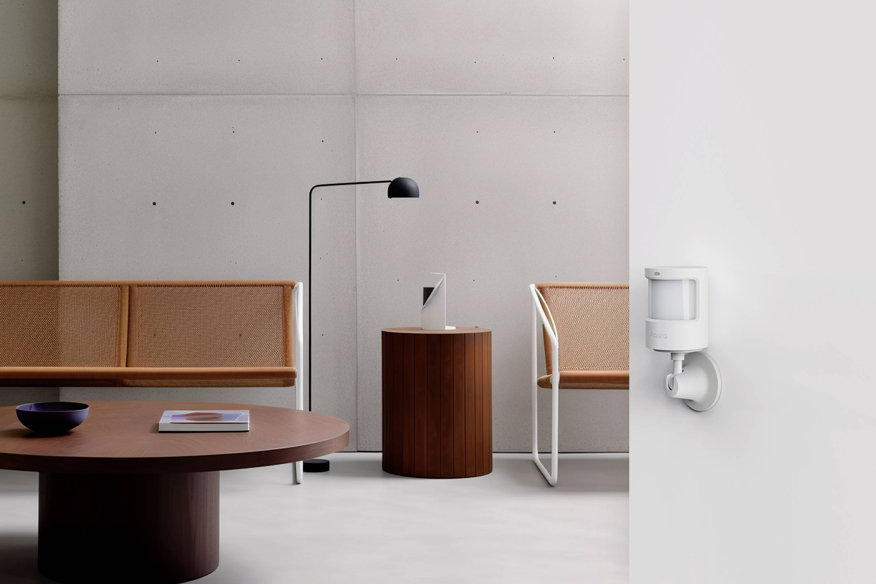 Nowoczesna poczekalnia z minimalistycznym wystrojem: drewniany stół, ławki, lampa stojąca i czujnik ruchu na ścianie.