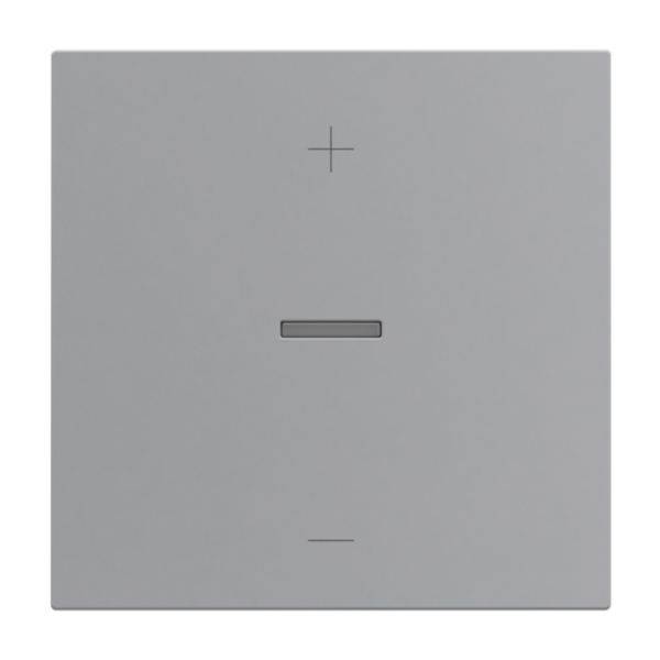 Szary przełącznik świetlny z pionowym paskiem pośrodku oraz znakiem plus u góry i znakiem minus u dołu.