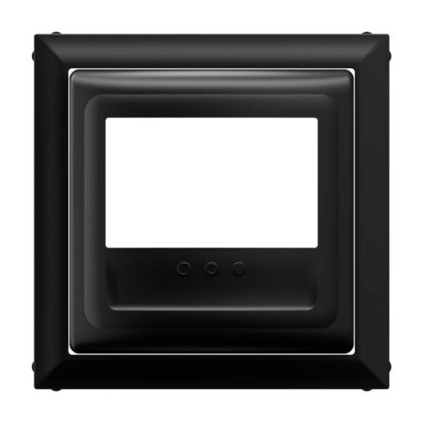 Czarny ramka z prostokątnym zagłębieniem i trzema małymi punktami u dołu, prawdopodobnie do elektronicznego wyświetlacza lub panelu sterowania.