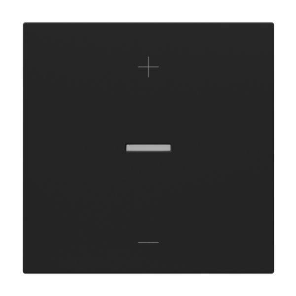 Czarny włącznik światła z białym znakiem plus u góry i poziomą kreską pośrodku do obsługi.