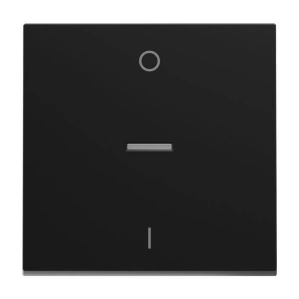 Czarny przełącznik kołyskowy z kołem u góry i literą 'I' na dole, wskazujący pozycje włączenia i wyłączenia.