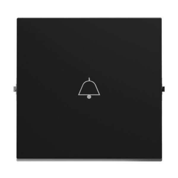 Czarny kwadratowy przycisk z symbolem dzwonka pośrodku, prawdopodobnie przeznaczony jako przycisk dzwonka lub przycisk alarmowy.
