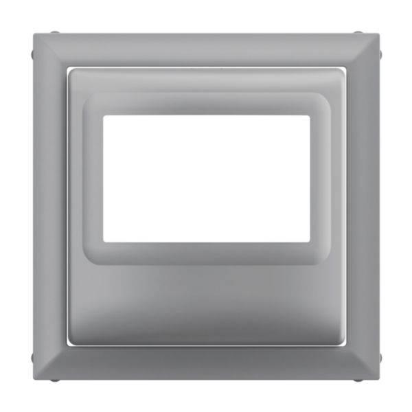 Metalowy ramka włącznika światła w kształcie kwadratu, w kolorze srebrnym, o nowoczesnej, gładkiej powierzchni.
