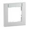 Jasnoszara, kwadratowa ramka z wycięciem pośrodku, odpowiednia do włączników lub gniazd elektrycznych, z przezroczystym elementem u góry.