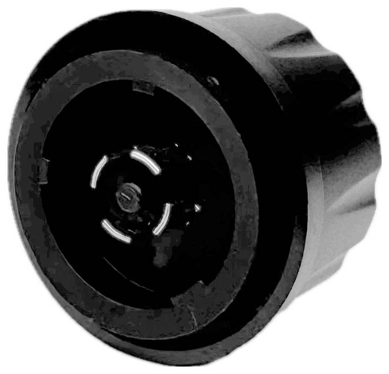 Czarny korpus urządzenia o okrągłym kształcie z żebrowaną krawędzią; centralne zagłębienie z koncentrycznymi kołami. Służy do regulacji.