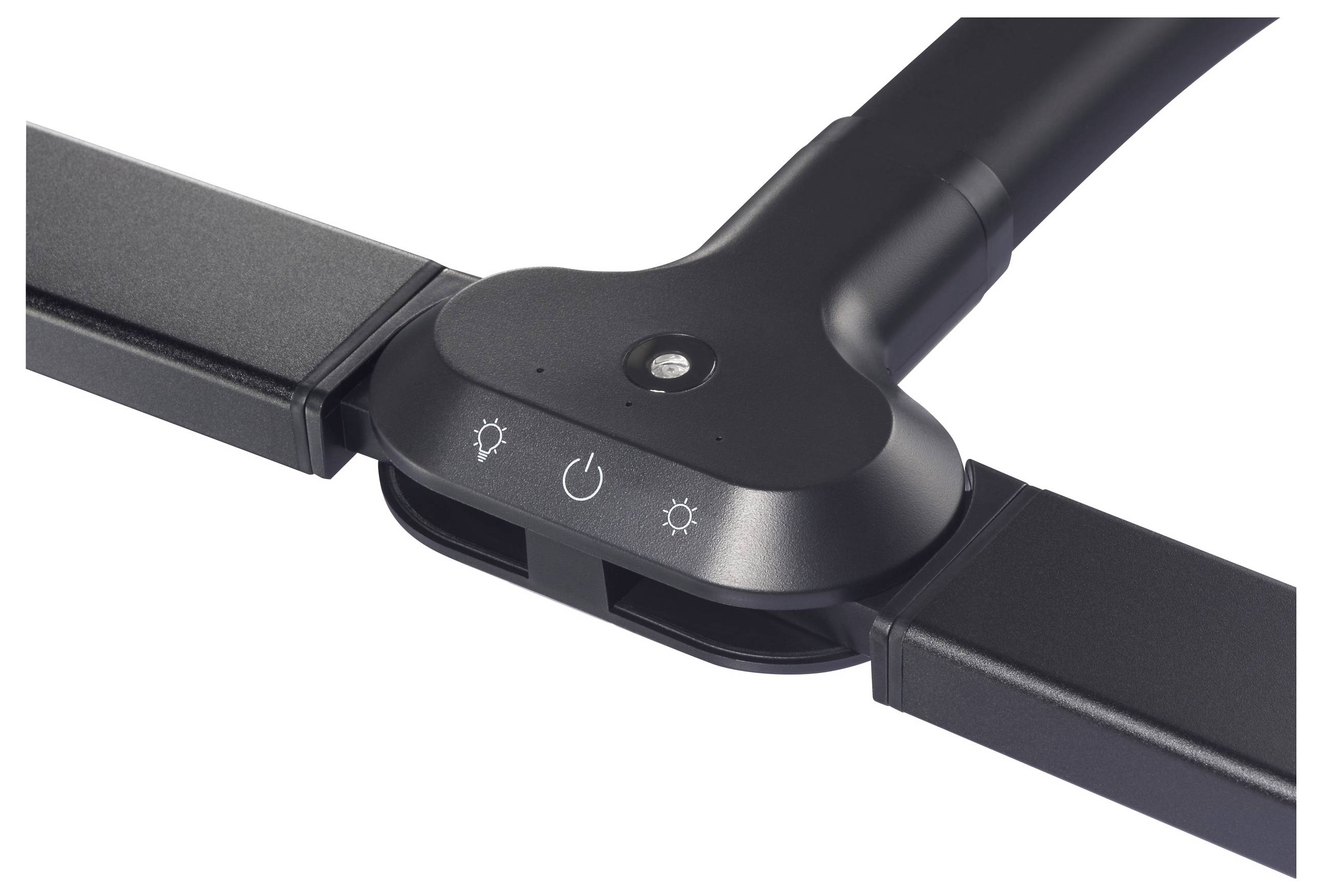 Czarny, prostokątny obiekt z trzema symbolami: słońce, koło z punktem, słońce. Posiada mały, okrągły przycisk pośrodku.