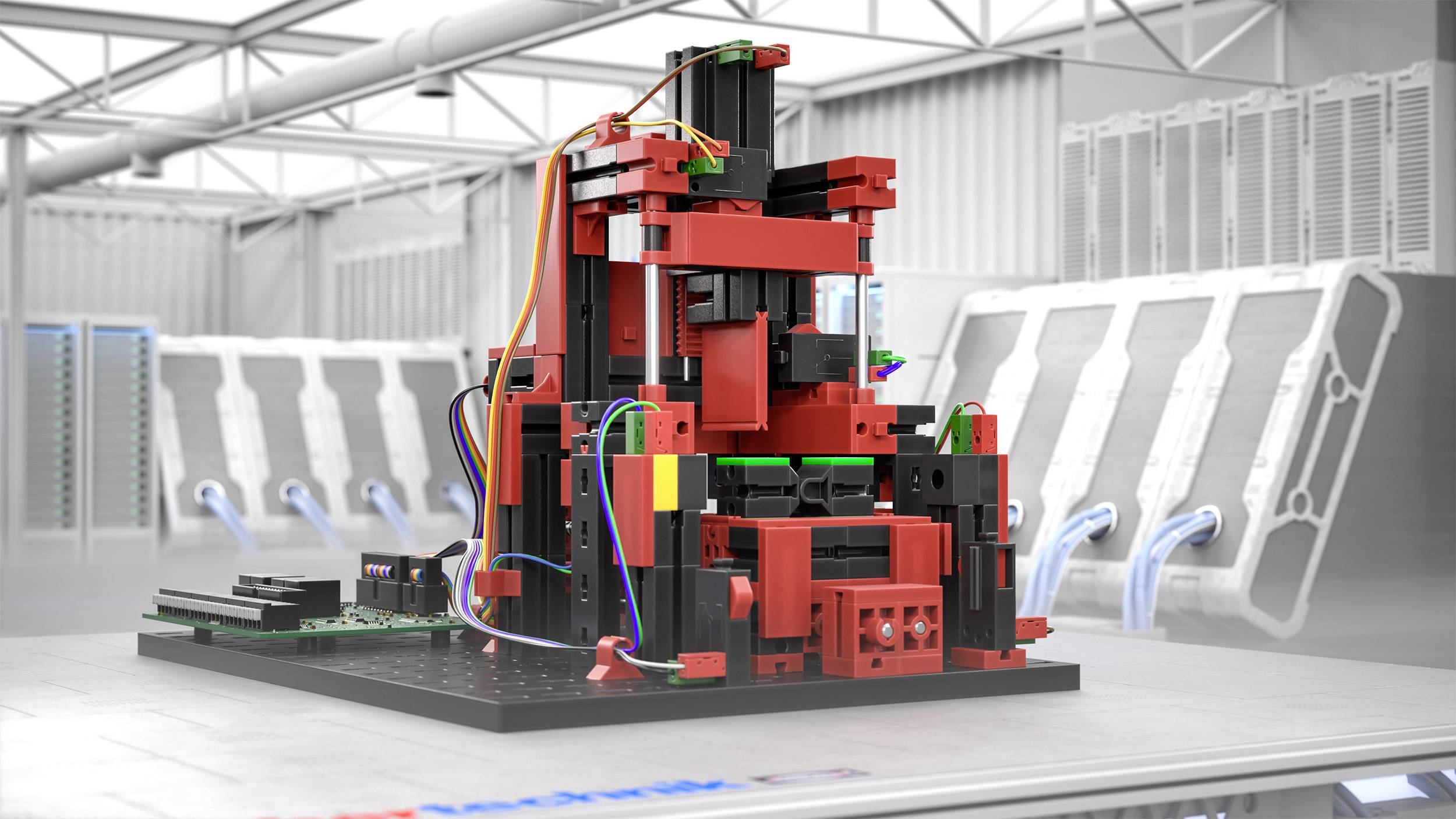 Skomplikowany, wielokolorowy model Lego stoi na stole w nowoczesnym, przemysłowym pomieszczeniu. W tle widoczne są urządzenia techniczne.