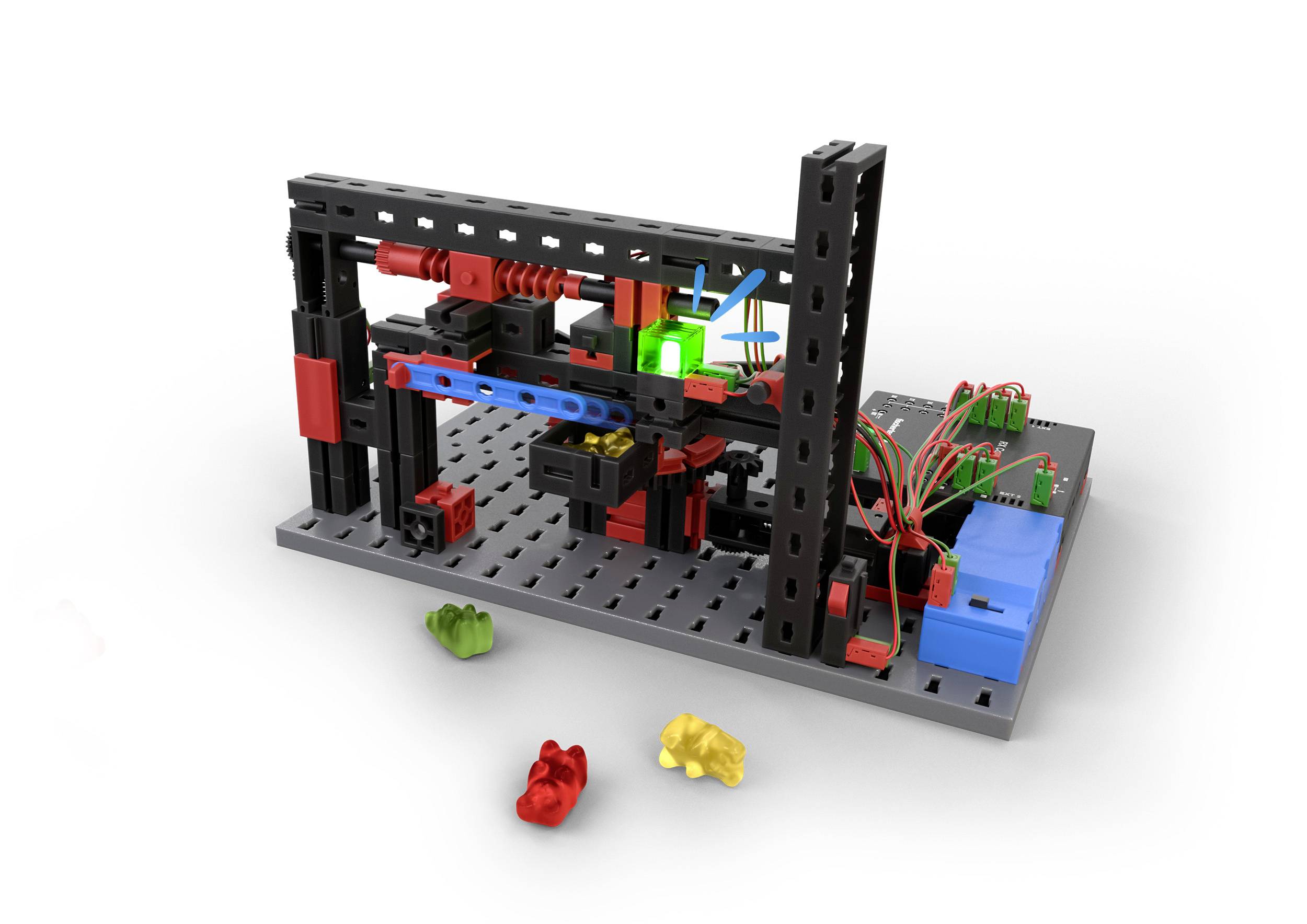 Model zestawu modułowego robota sortującego na płycie z różnymi częściami, wyświetlaczem LED i kolorowymi plastikowymi obiektami.