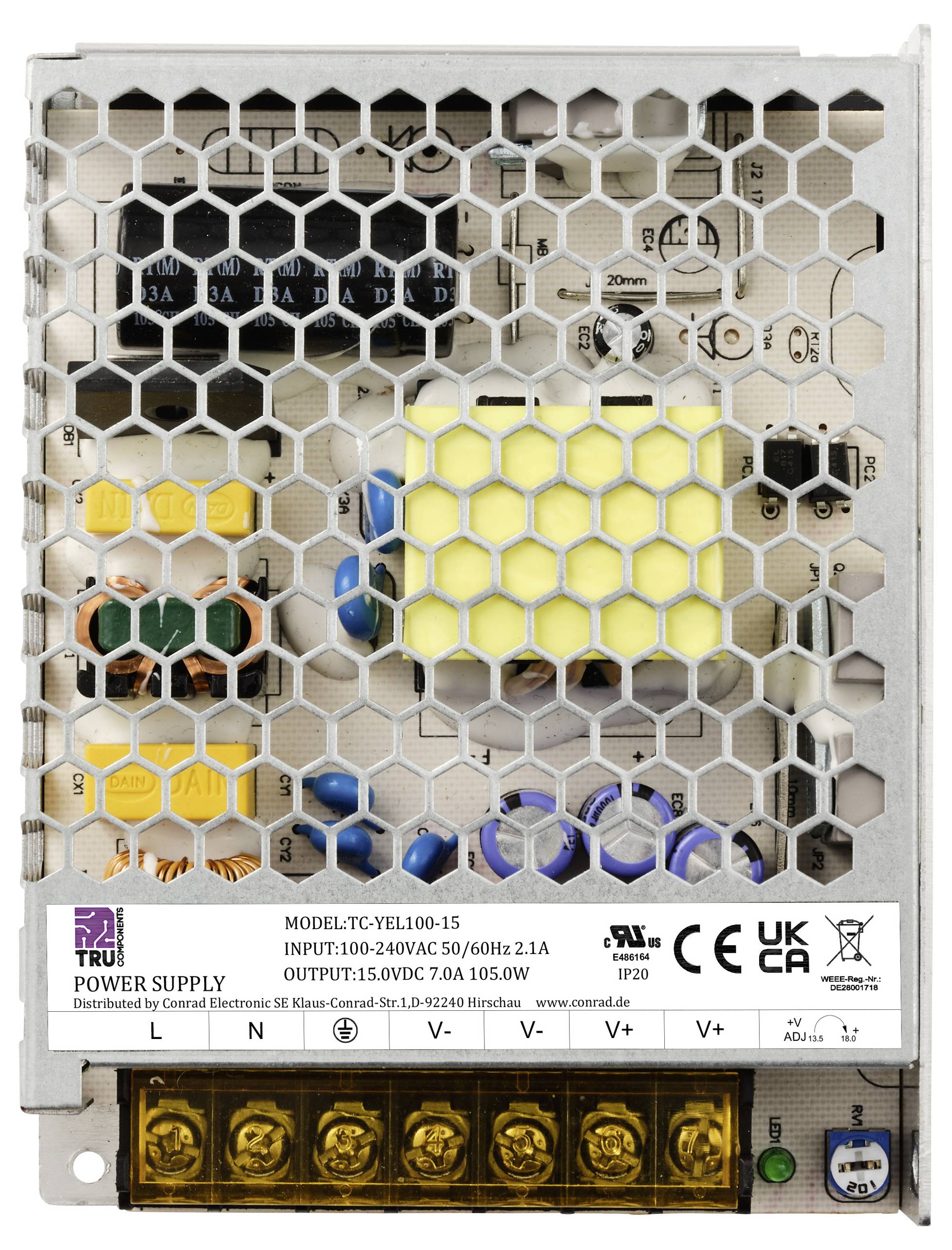 Zasilacz w metalowej obudowie o numerze modelu 'TC-YEL100-15', wejście 100-240V, wyjście 15V. Widoczne certyfikaty CE i UKCA.