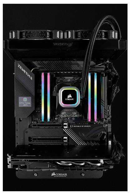 Otwarty komputer prezentuje płytę główną z podświetlanymi na RGB pamięciami RAM oraz elementem chłodzącym marki Corsair.