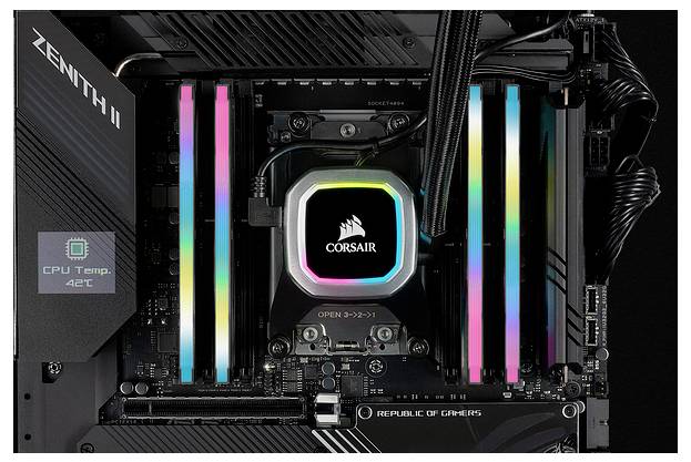 Płyta główna komputera z podświetlanymi RGB kośćmi pamięci RAM i chłodzeniem procesora. Wyświetlacz pokazuje 'Temp. CPU 46°C'. Płyta główna z serii 'Republic of Gamers'.