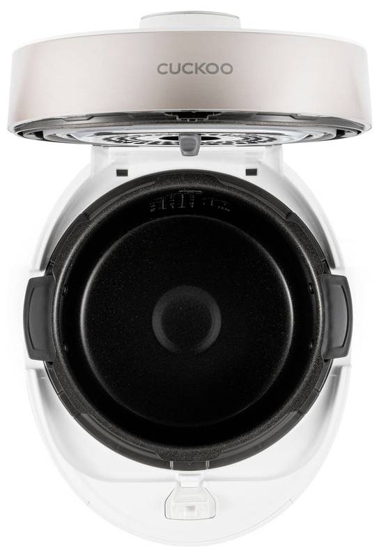 Otwarty garnek do gotowania ryżu widziany z góry, o równomiernym, okrągłym kształcie, z czarnym, okrągłym wewnętrznym wkładem i białą obudową zewnętrzną.