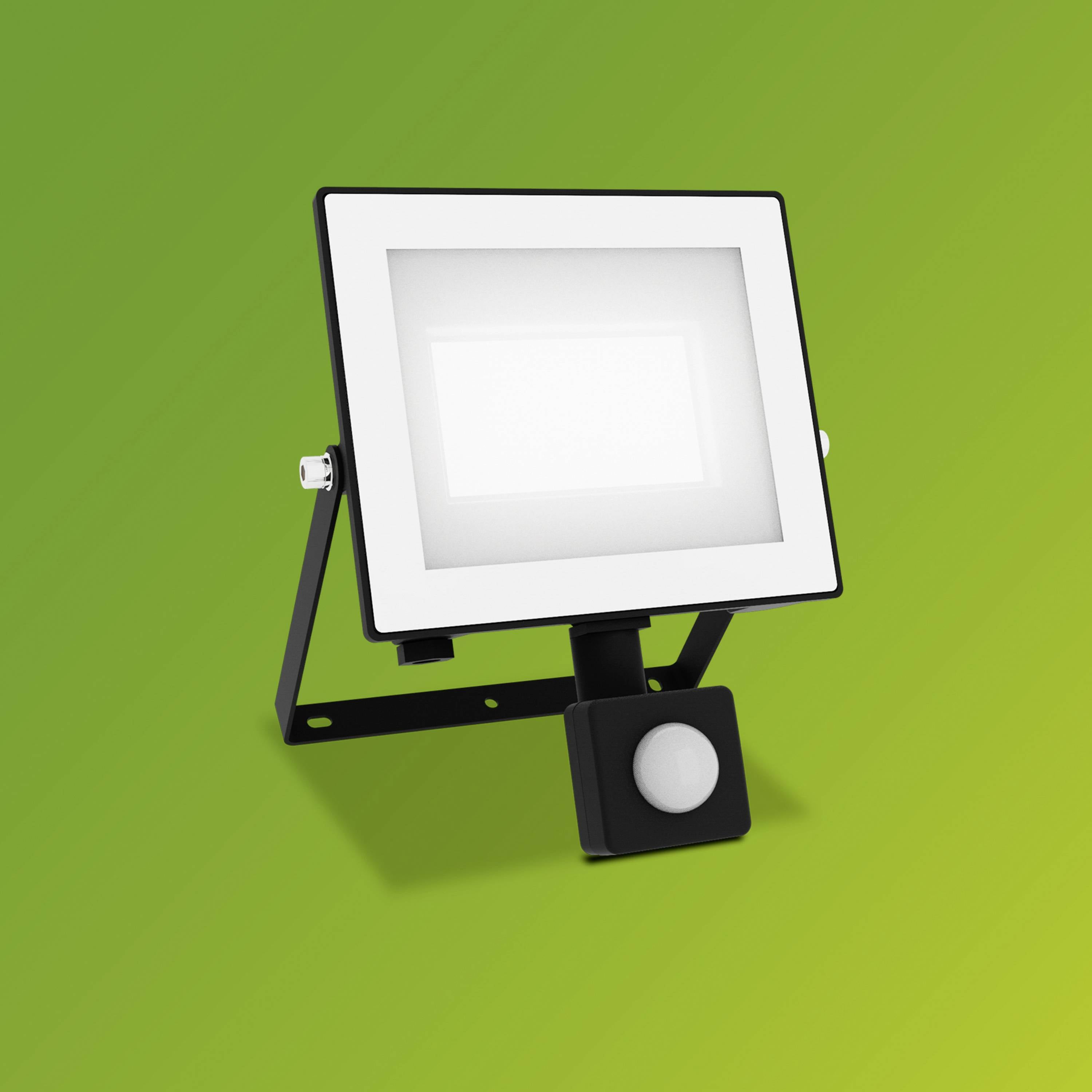 Prostokątny reflektor LED z czujnikiem ruchu na zielonym tle, przeznaczony do oświetlania przestrzeni zewnętrznych.