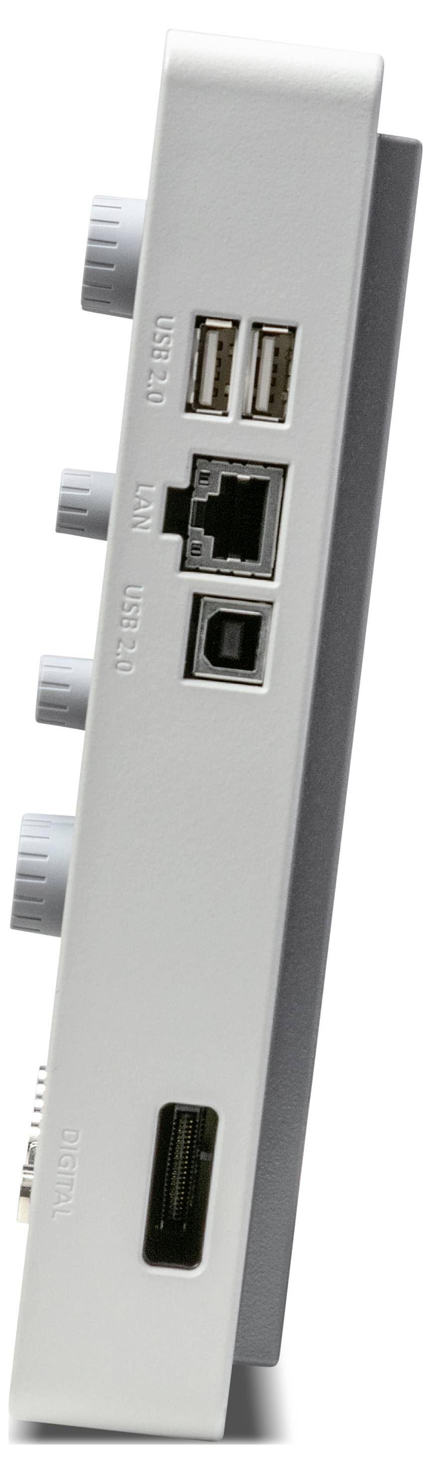 Widok z boku urządzenia elektronicznego z wieloma portami, w tym portami USB, Ethernet oraz złączami audio.