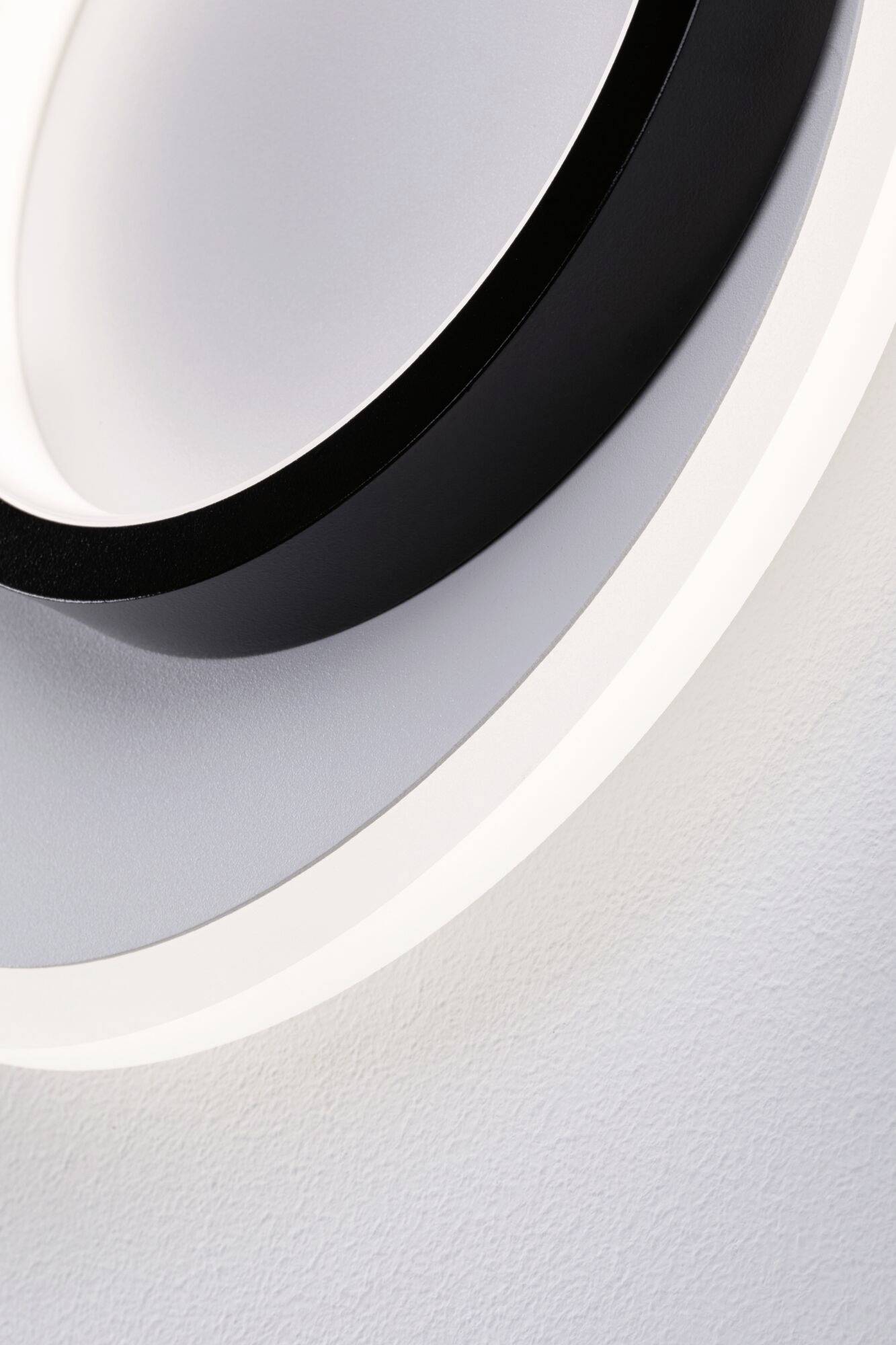 Abstrakcyjne zbliżenie okrągłych lamp LED w kolorach czarnym, białym i szarym, przedstawiające nowoczesną i minimalistyczną estetykę.