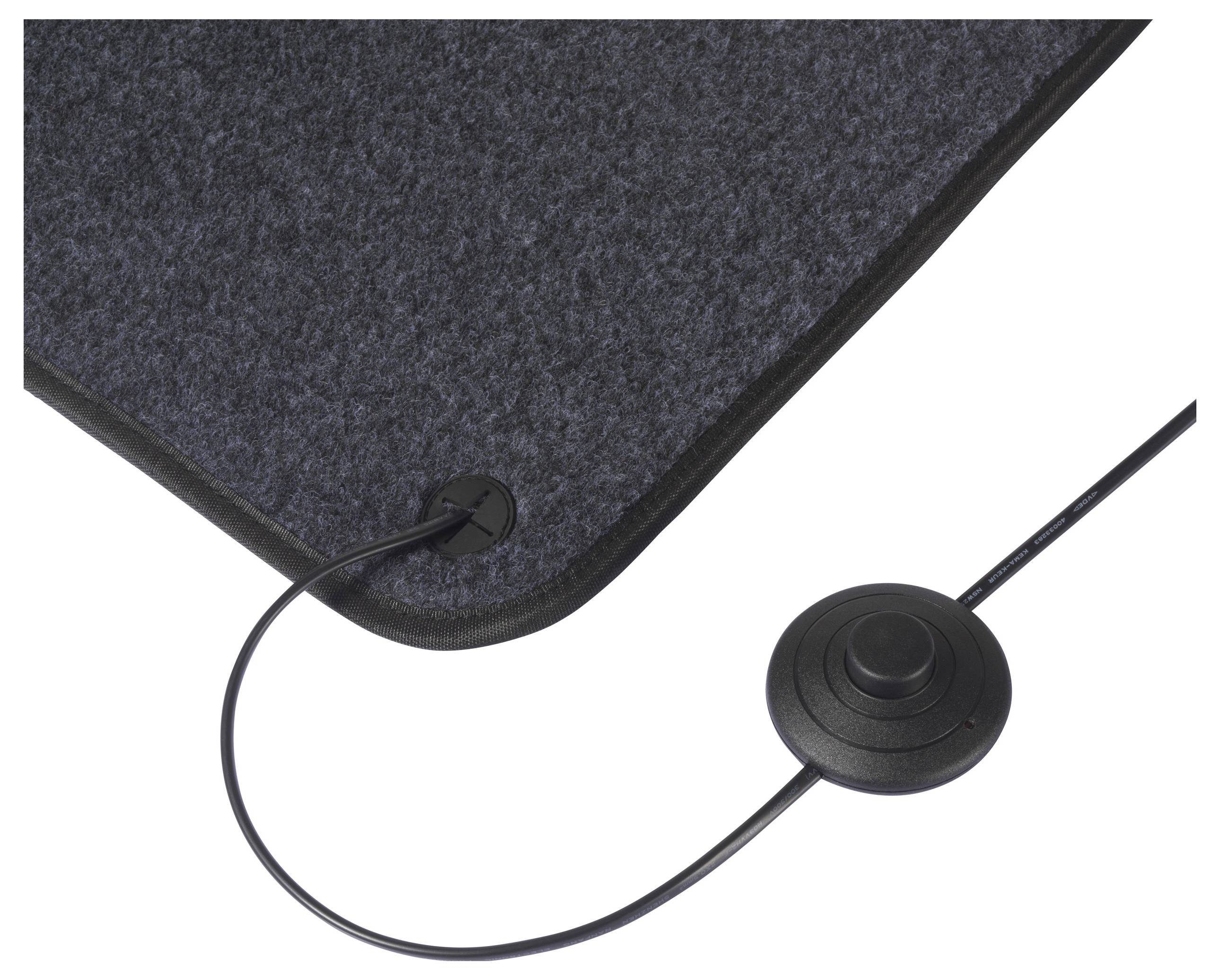 Zbliżenie ciemnawej elektrycznej mata z przewodem i okrągłym przyciskiem sterowania, stosowanej do ogrzewania lub celów terapeutycznych.