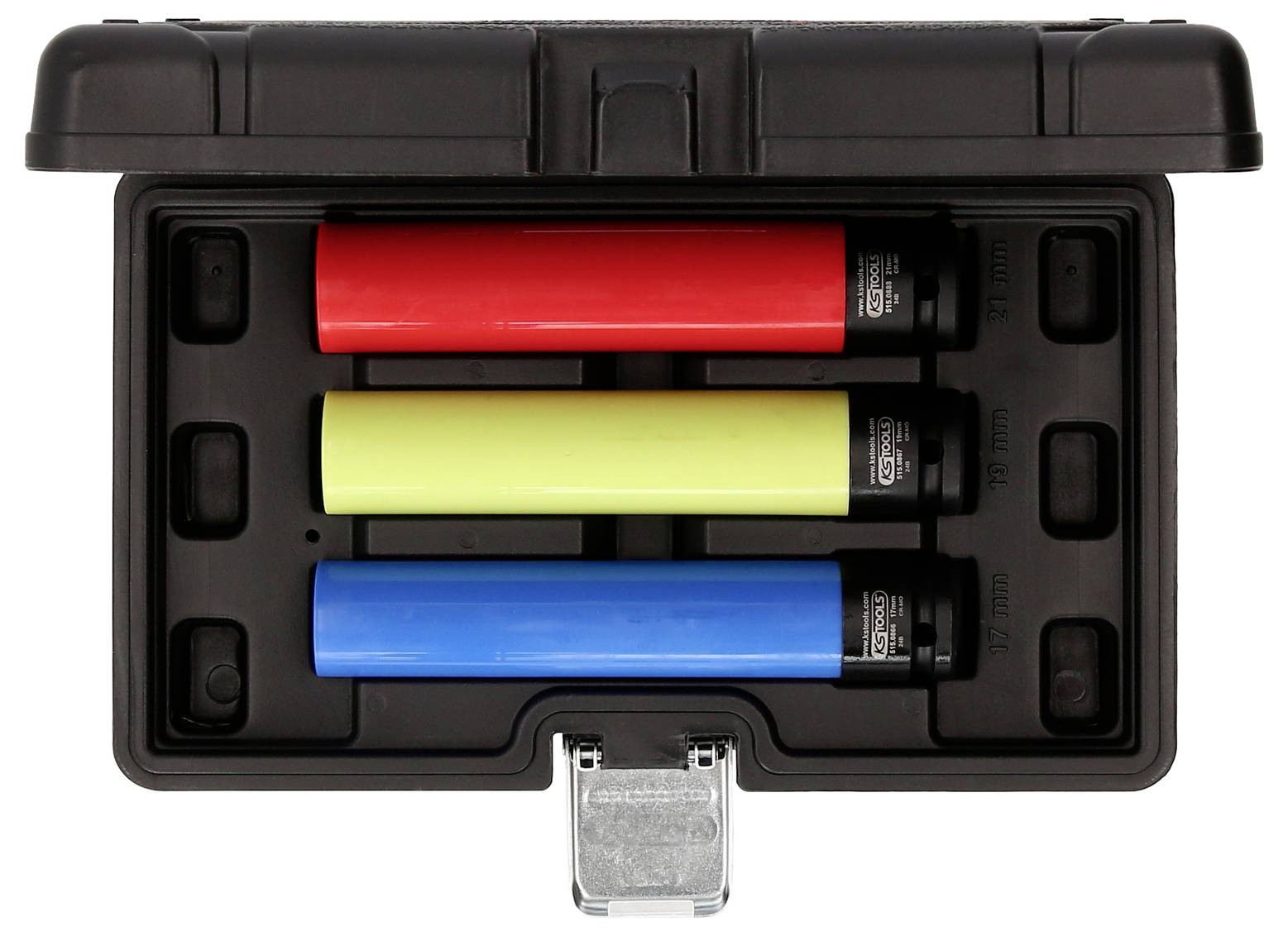 Trzy kolorowe cylindry w czarnym pudełku: czerwony, żółty i niebieski. Pudełko jest otwarte, ukazując symetryczne ułożenie.