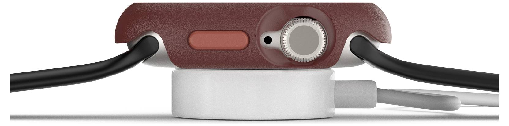 Smartwatch w ujęciu bocznym, obudowa w kolorze czerwono-brązowym, cyfrowa korona, czerwony przycisk, leżąca na magnetycznej ładowarce.