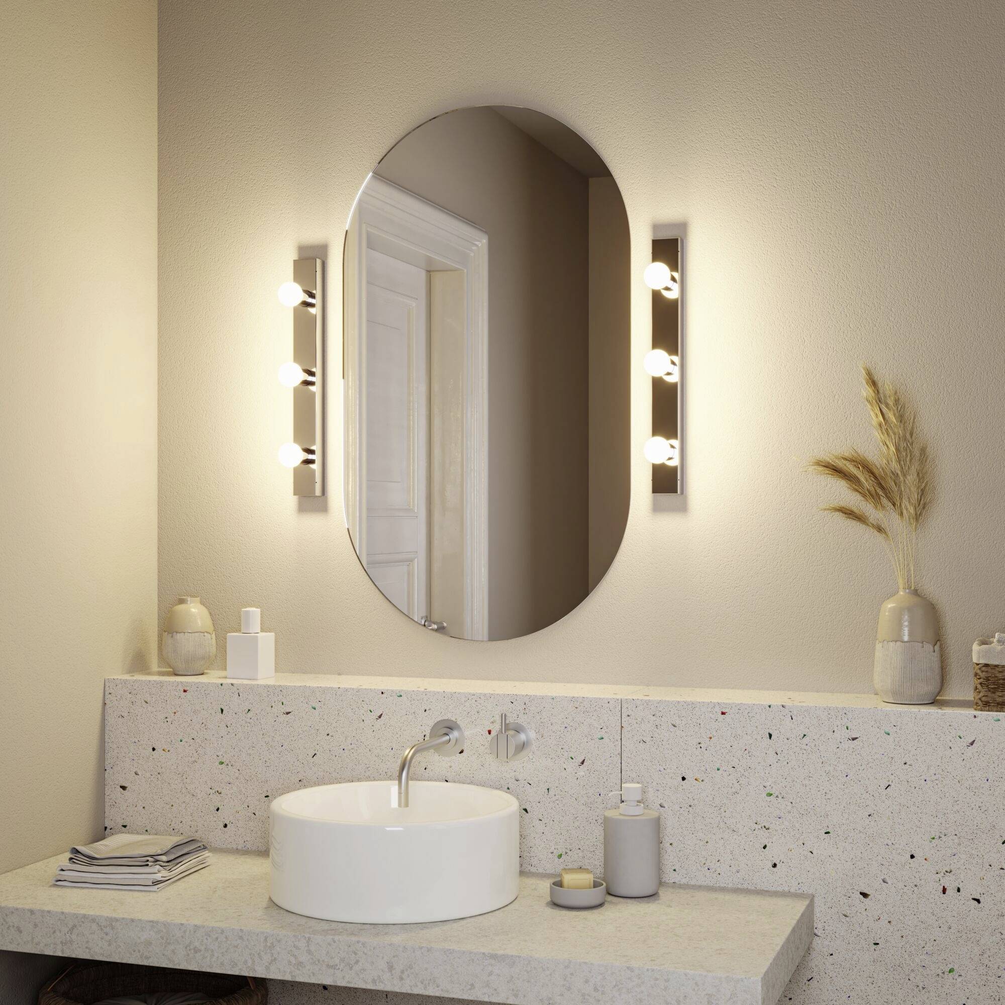 Owalny lustro z bocznym oświetleniem nad nowoczesną umywalką, wmontowane w beżowy blat z marmuru, w atmosferze łazienki.