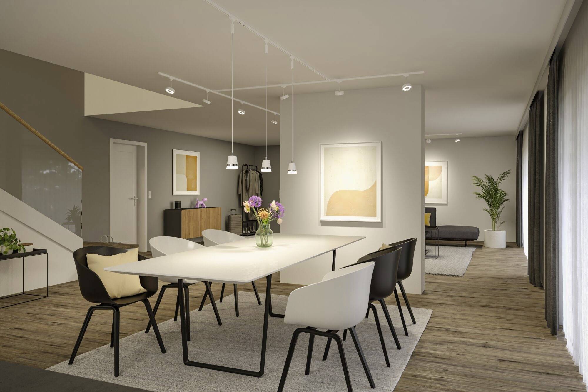 Jadalnia z nowoczesnym stołem, sześcioma krzesłami, kwiatową dekoracją centralną. W tle: dzieła sztuki, jasne pomieszczenie, drewniana podłoga, sofa i roślina.