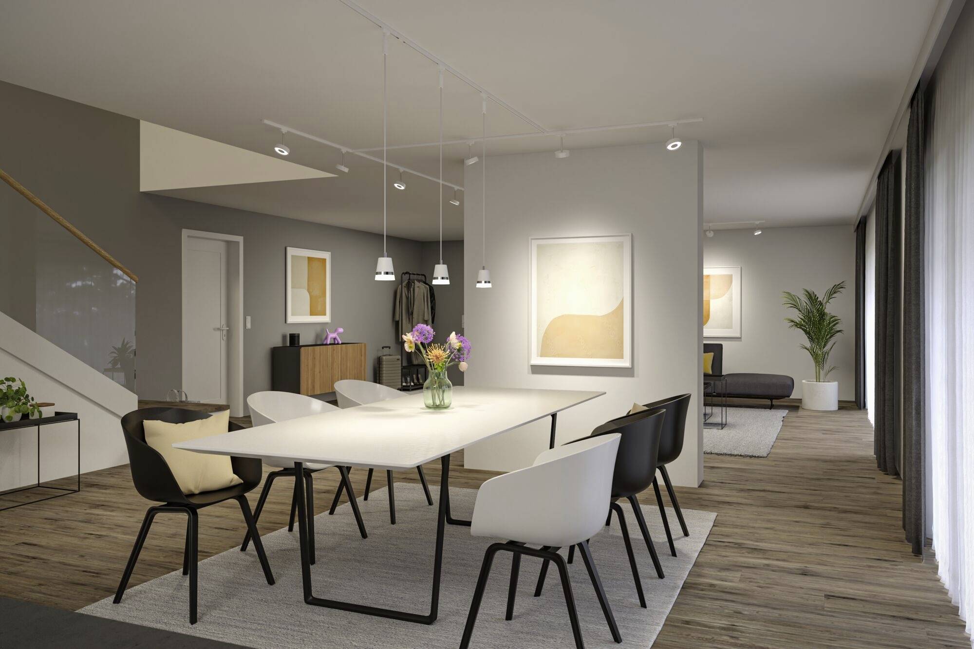 Jadalnia z dużym stołem i sześcioma krzesłami, nowoczesnymi dziełami sztuki na ścianach i jasnym, przytulnym oświetleniem. W tle widoczny salon.