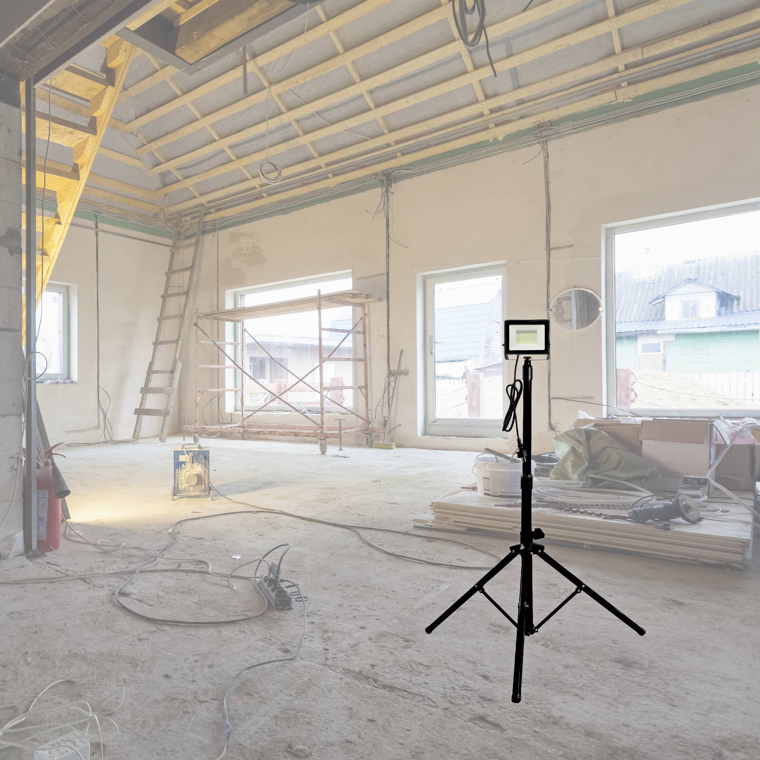 'Pusty pokój w budowie, z otwartymi oknami i przenośną lampą pośrodku. Drabiny i materiały budowlane są rozrzucone dookoła.'