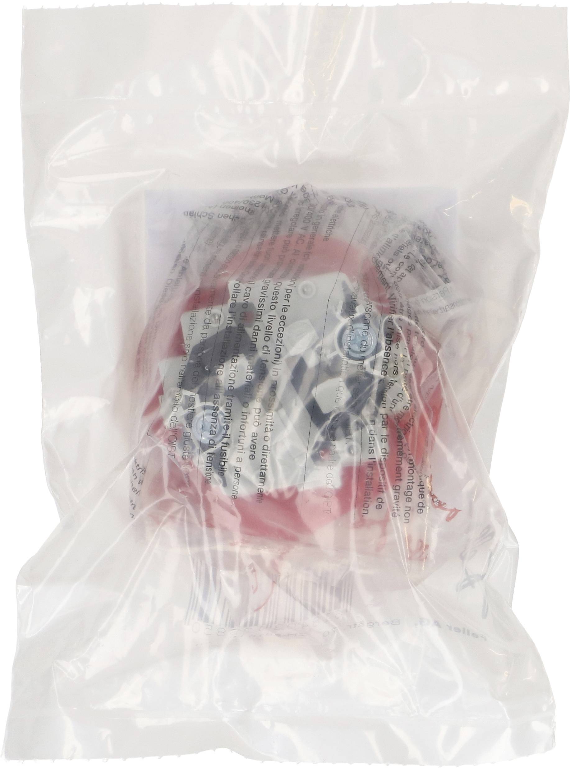 Czerwono-biały produkt w przezroczystym opakowaniu plastikowym. Napis na opakowaniu jest częściowo widoczny, ale trudny do odczytania.