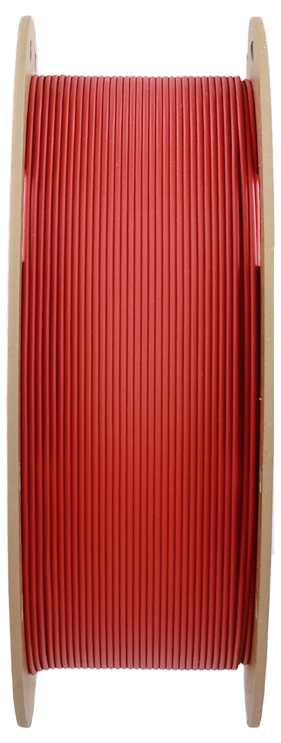 Duża szpula czerwonego kabla, ustawiona pionowo, widok z boku.