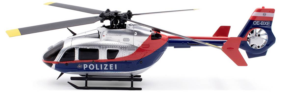 Zabawkowy model helikoptera policyjnego w kolorach niebieskim i czerwonym, z napisem 'Policja' z boku.