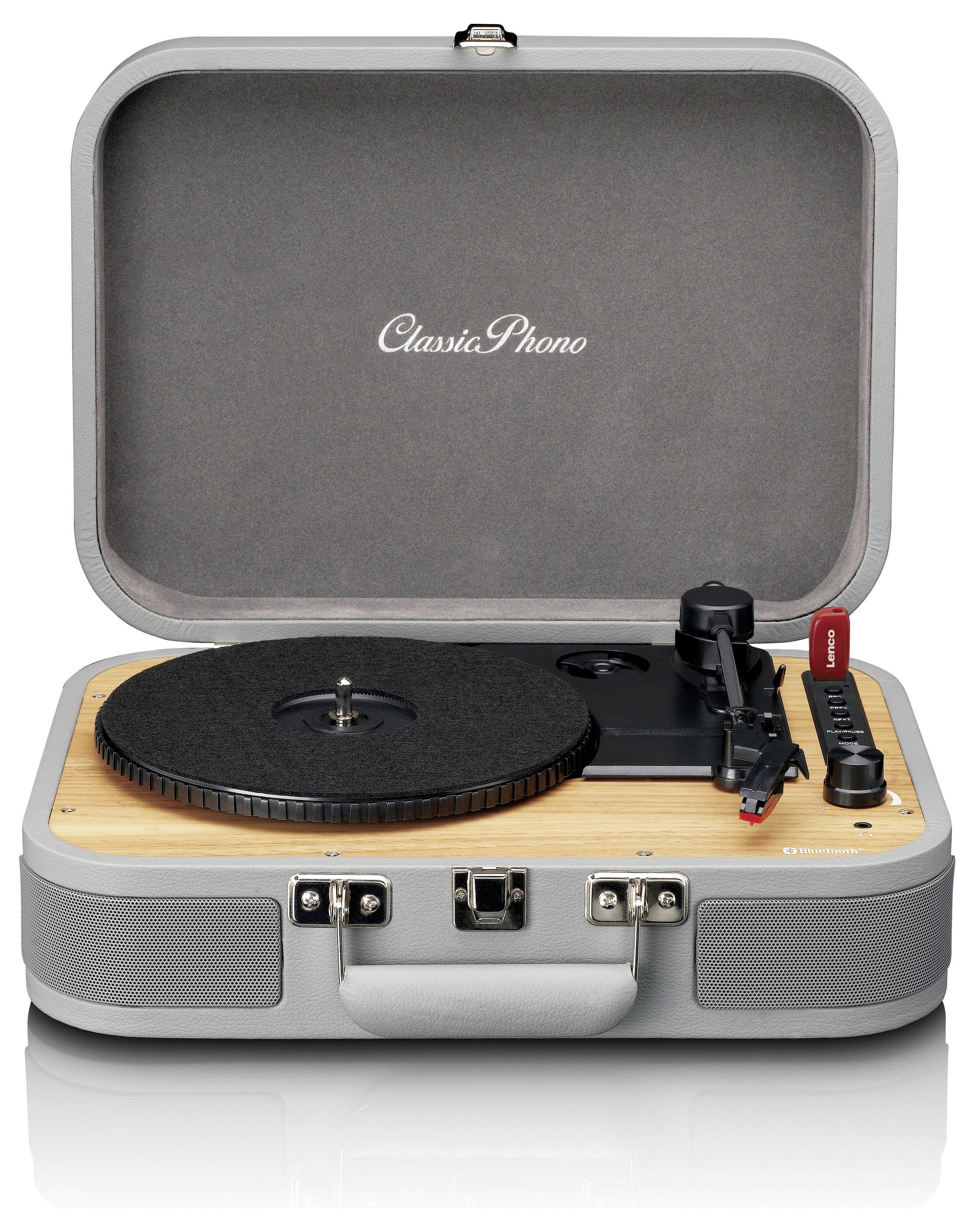 'Kompaktowy gramofon w szarym designie walizki z drewnianą dekoracją, oznaczony jako Classic Phono. Otwarty, gotowy do użycia, widoczne są przyciski sterujące.'