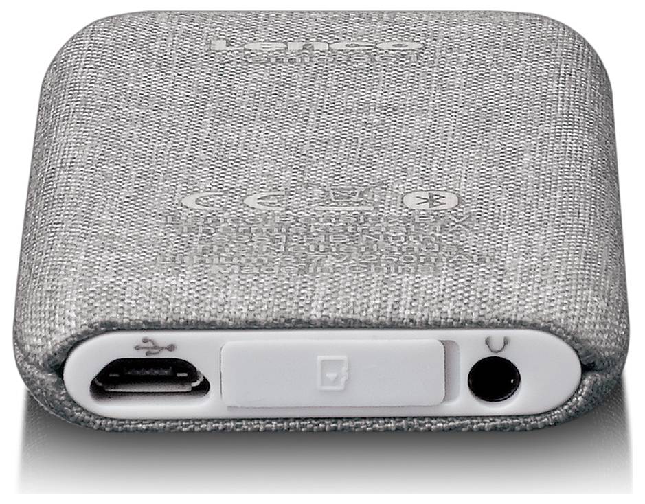 Szary głośnik z tkaniną, z widocznymi złączami USB i audio.