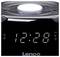 Czarny radiobudzik z wyświetlaczem cyfrowym pokazuje godzinę 12:28. Na górze znajduje się regulator głośności.