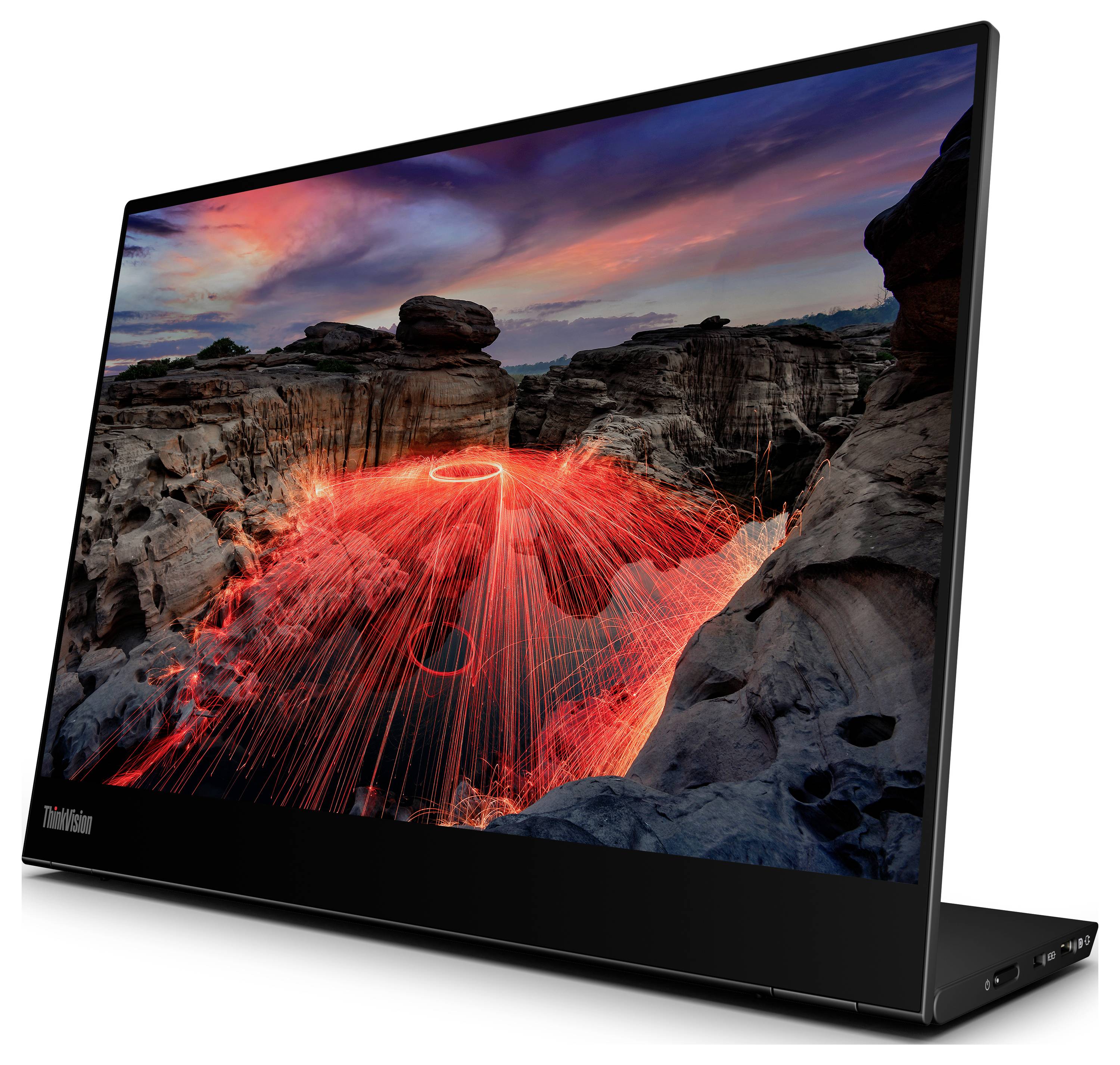 Laptop z wysoko rozdzielczym ekranem wyświetla zdjęcie kanionu o zachodzie słońca oraz ślady świetlne wirowania stalowej wełny.