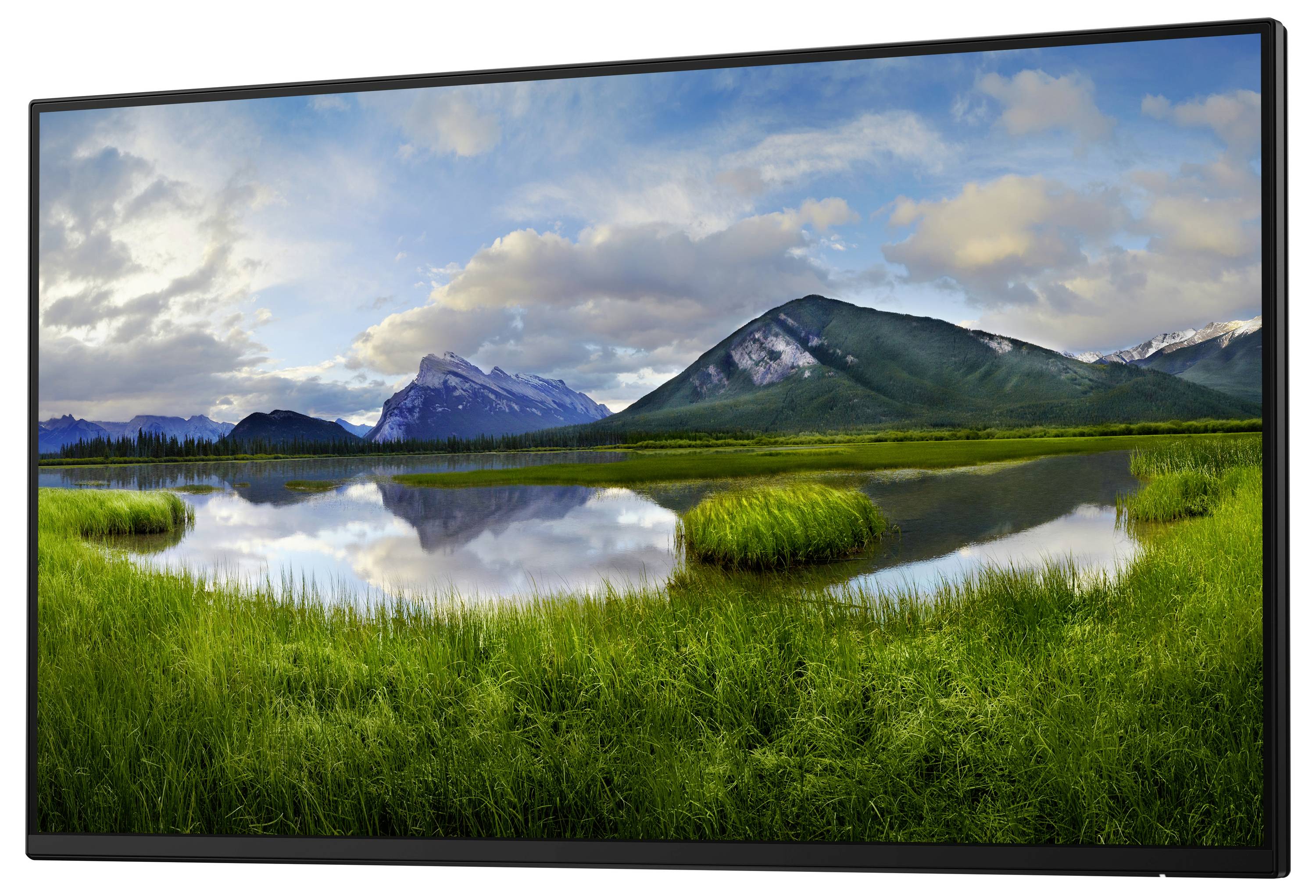 Spokojna sceneria z jeziorem na pierwszym planie, otoczona zielonymi łąkami oraz górami i zachmurzonym niebem w tle.