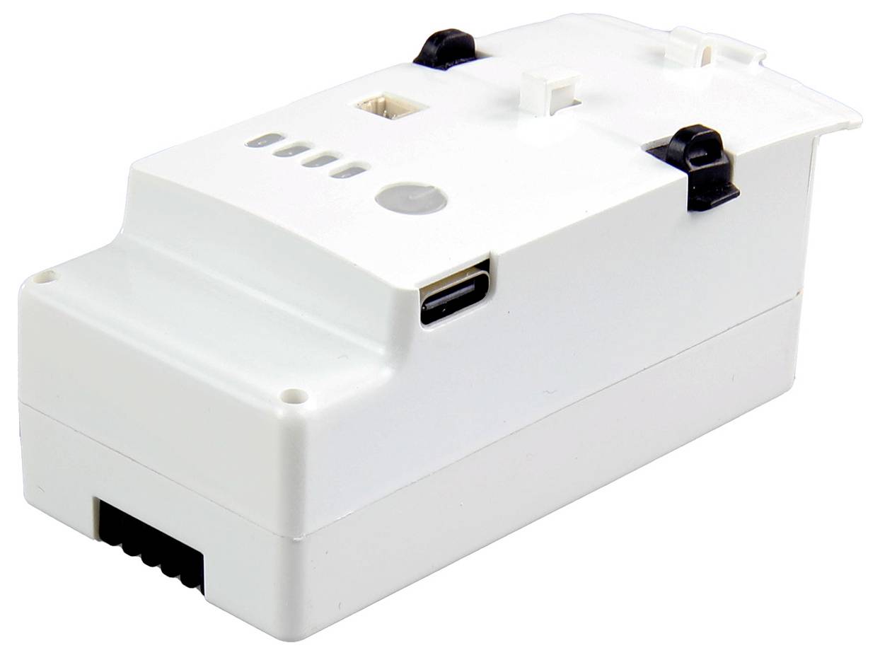 Białe urządzenie elektroniczne z wieloma złączami i przełącznikami na górnej powierzchni, prawdopodobnie stanowiące część większego systemu.