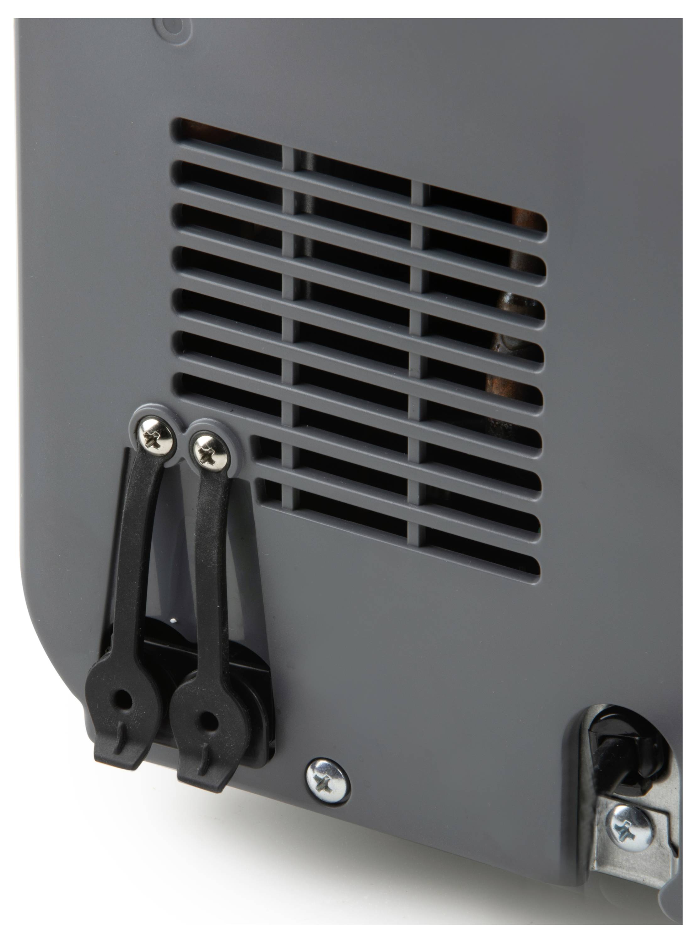 Szare urządzenie z otworami wentylacyjnymi i czarnymi elementami mocującymi. Prawa krawędź ujawnia fragment koła.