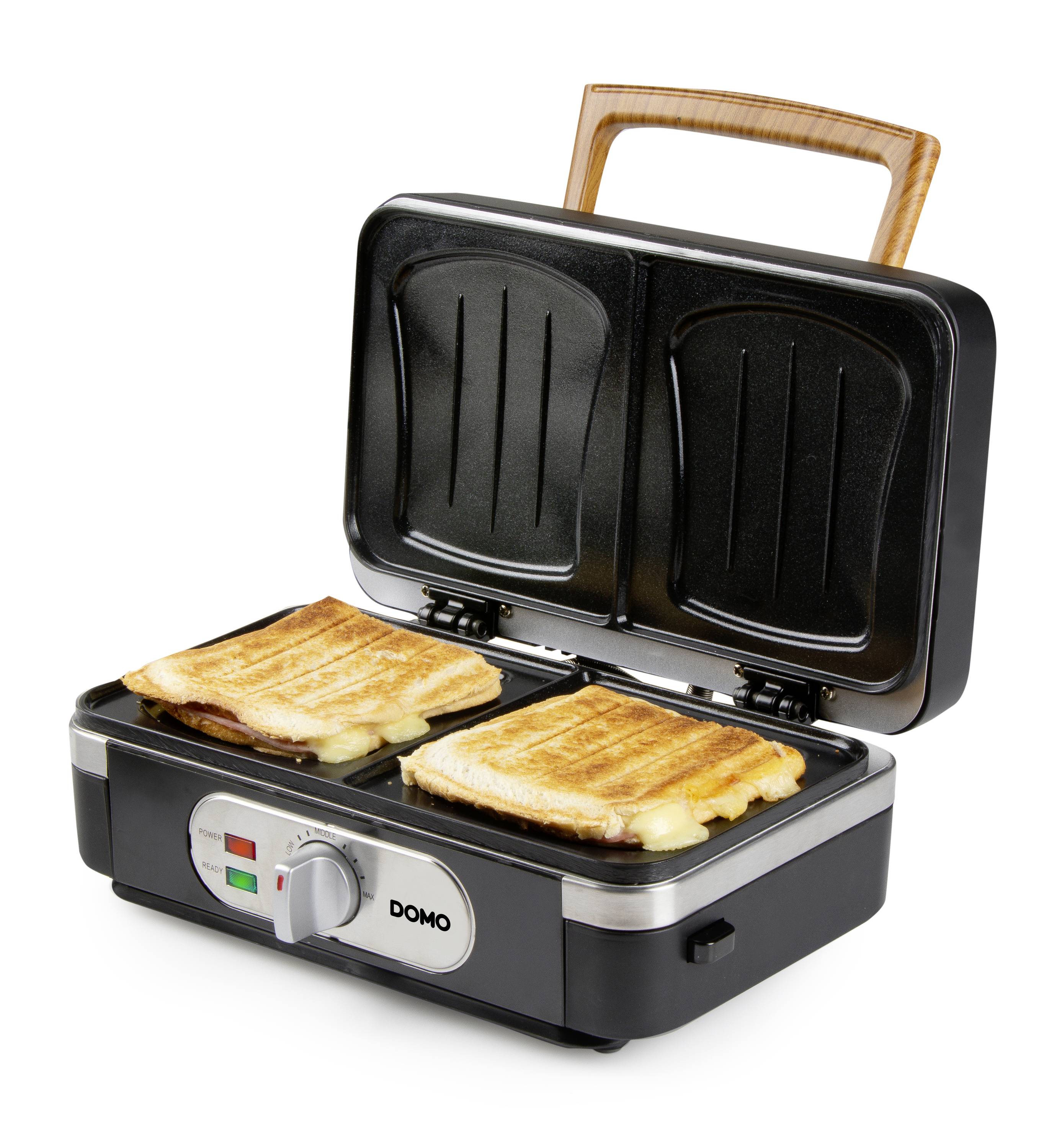 Maker do kanapek z otwartą pokrywą przedstawia dwie złotobrązowe, grillowane kanapki na powierzchni grzejacej.