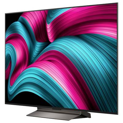 Na dużym telewizorze z płaskim ekranem wyświetlana jest żywa abstrakcyjna kompozycja z wirującymi różowymi i turkusowymi liniami.