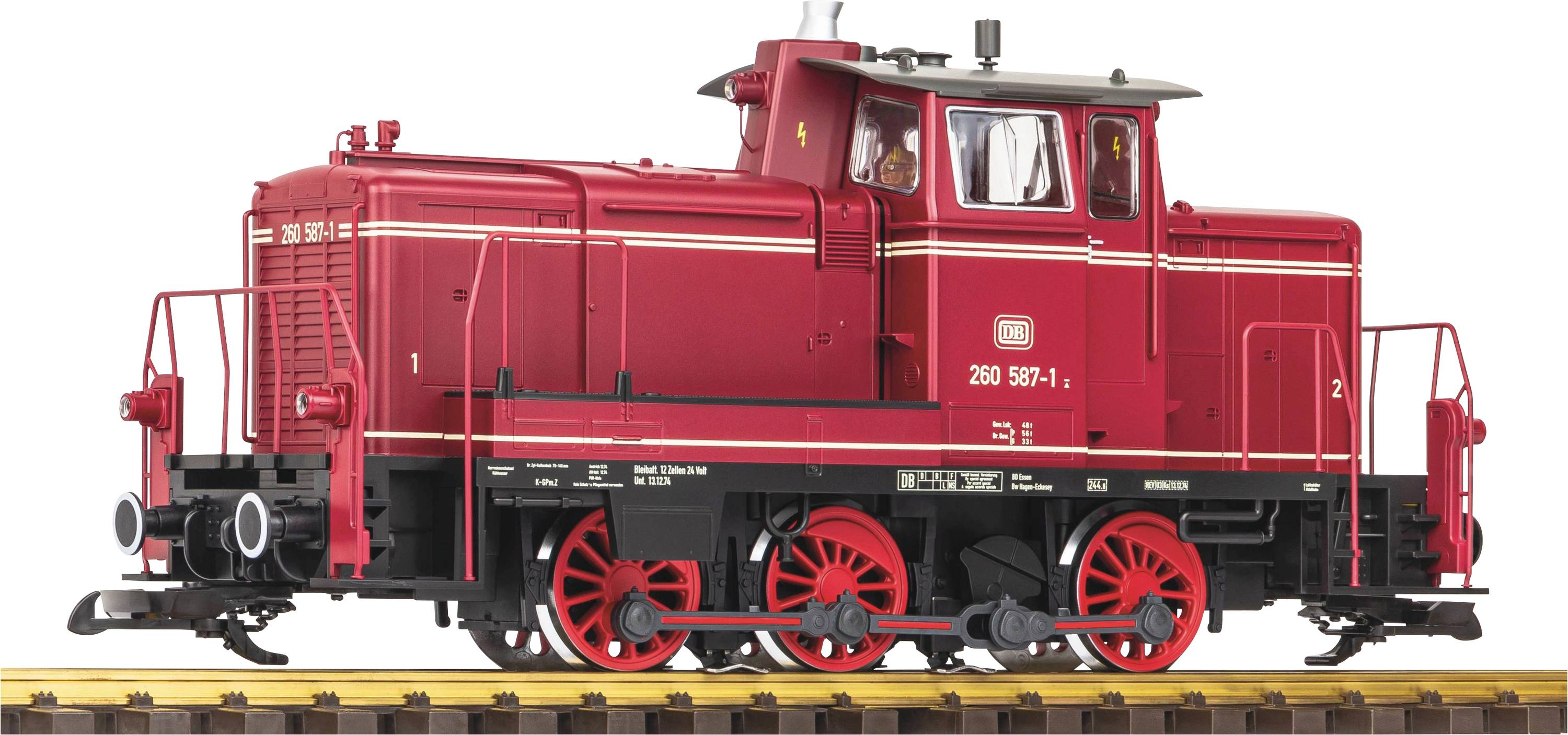 Czerwona lokomotywa spalinowa Deutsche Bahn, model 260 597-1, ustawiona bokiem na torach, z widocznymi szczegółami technicznymi.