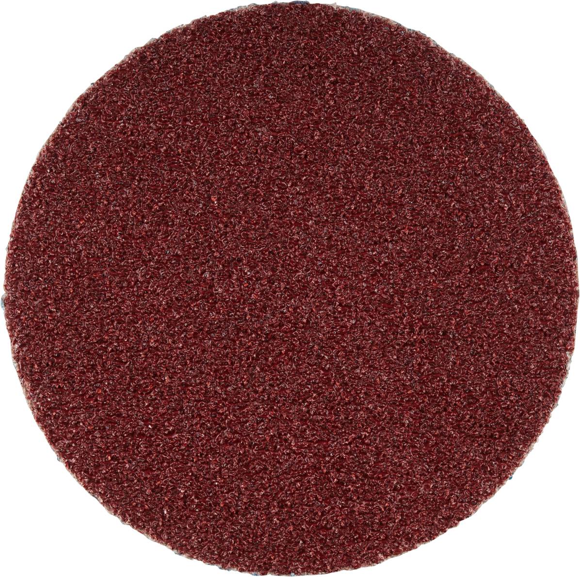 Okrągły, czerwony papier ścierny o grubym ziarnie, używany do prac szlifierskich.