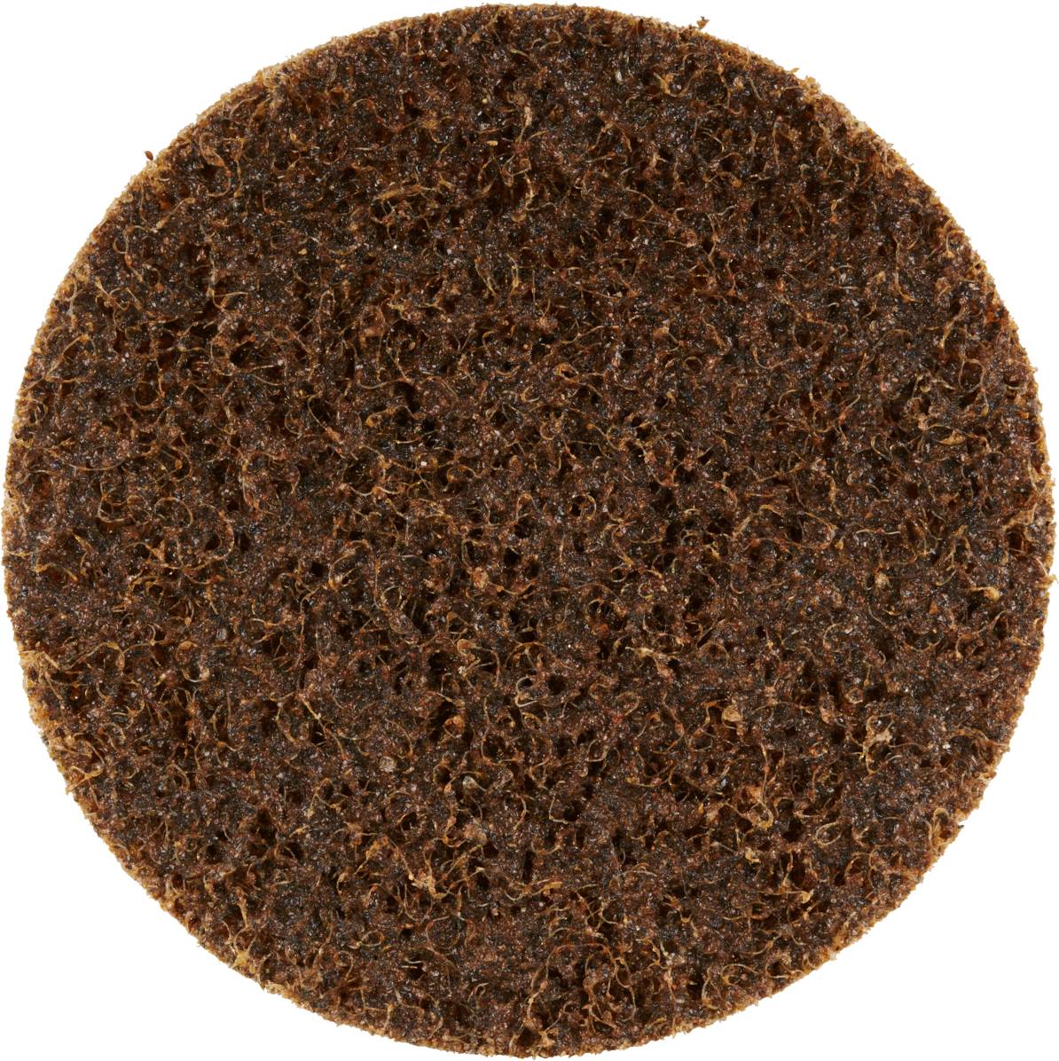 Zbliżenie okrągłej, brązowej tarczy o chropowatej, strukturalnej powierzchni. Prawdopodobnie służy do szlifowania lub polerowania.