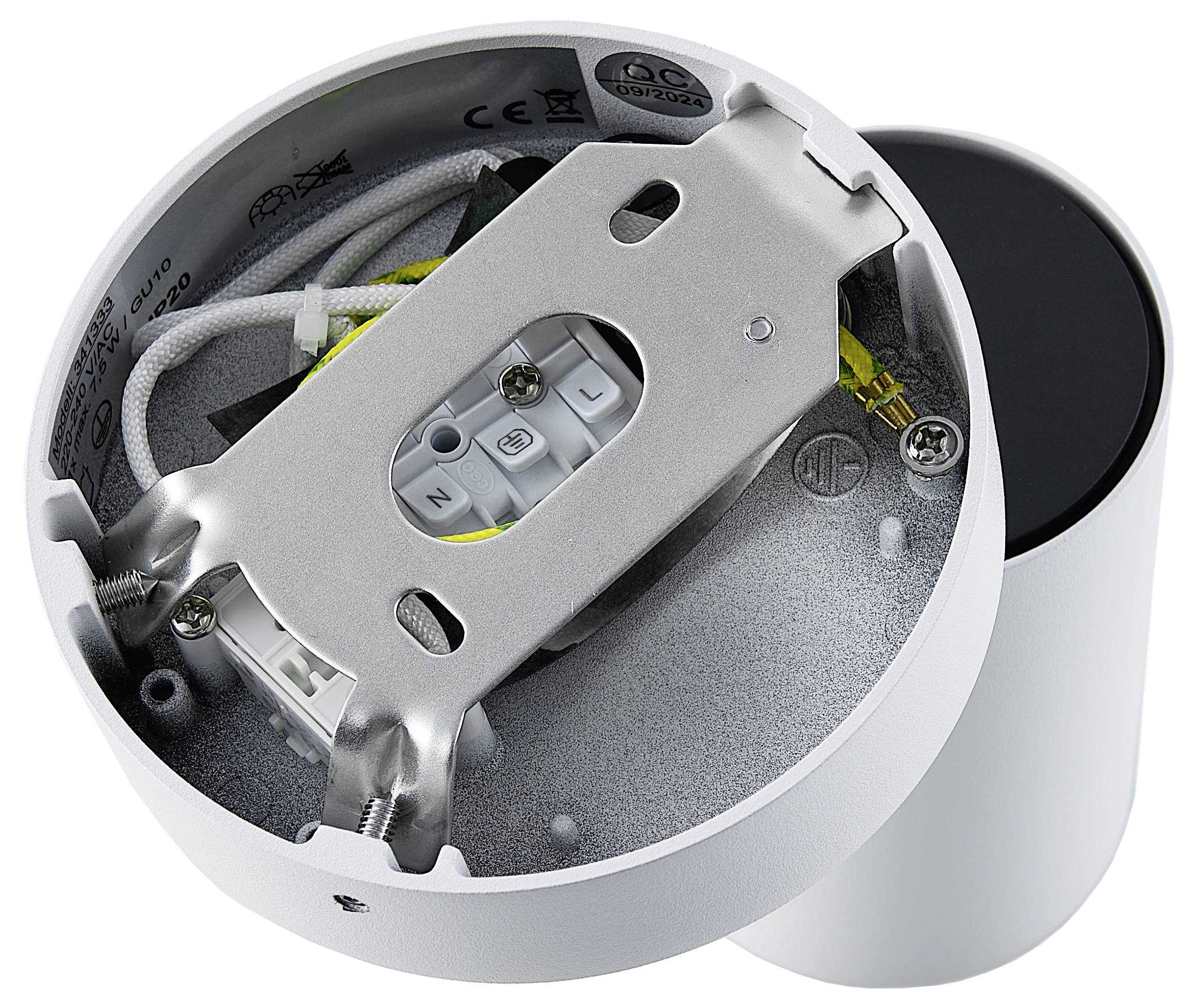 Otwarta biała cylindryczna lampa z widocznymi elementami elektrycznymi i przewodami wewnątrz.