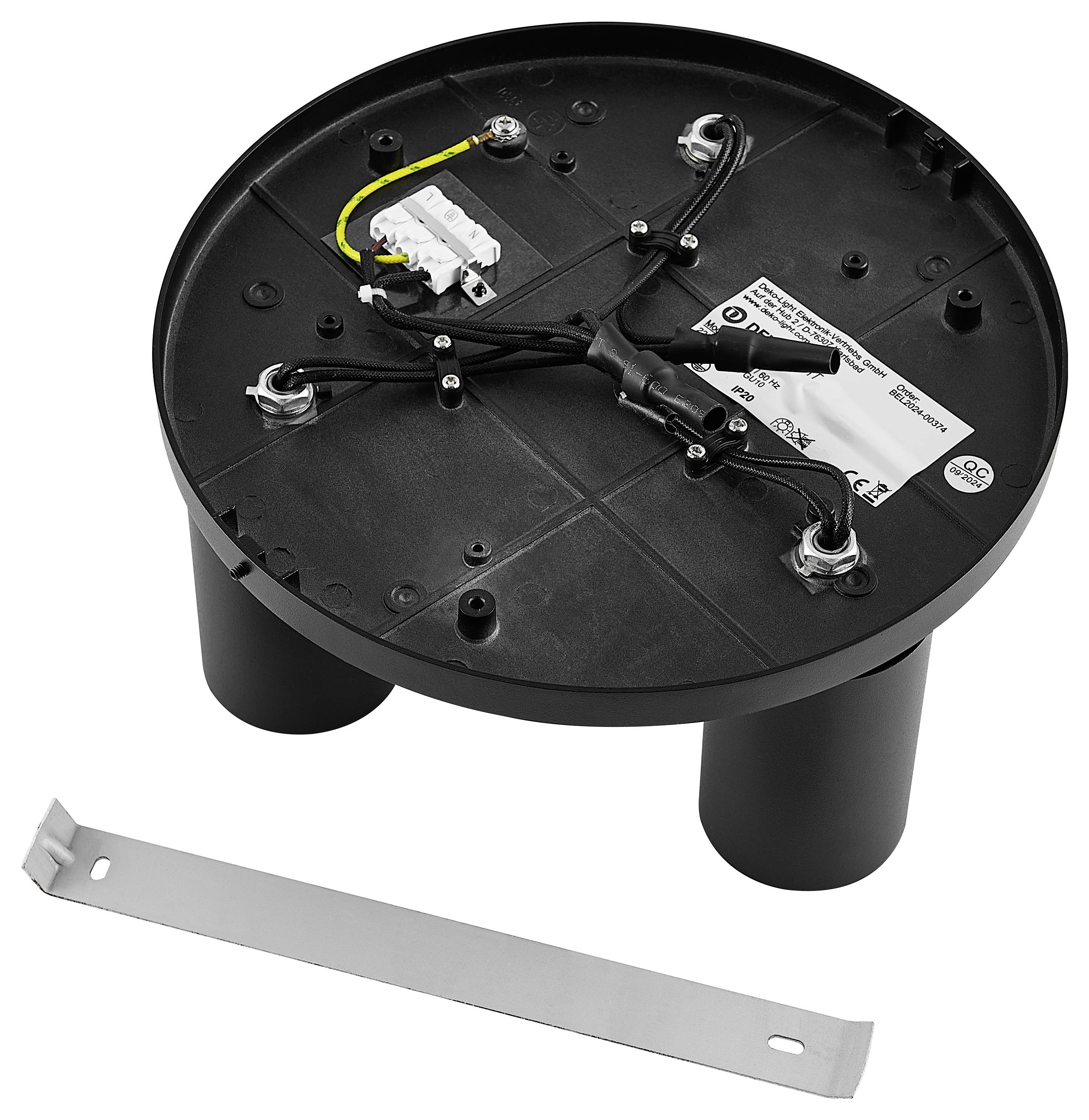 Okrągłe, czarne elektryczne pudełko przyłączeniowe z kablami i metalową listwą obok, prawdopodobnie część oprawy oświetleniowej.