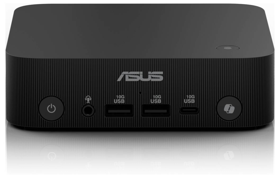 Czarny minikomputerowy komputer ASUS z dwoma portami USB, gniazdem słuchawkowym i przyciskiem zasilania z przodu.