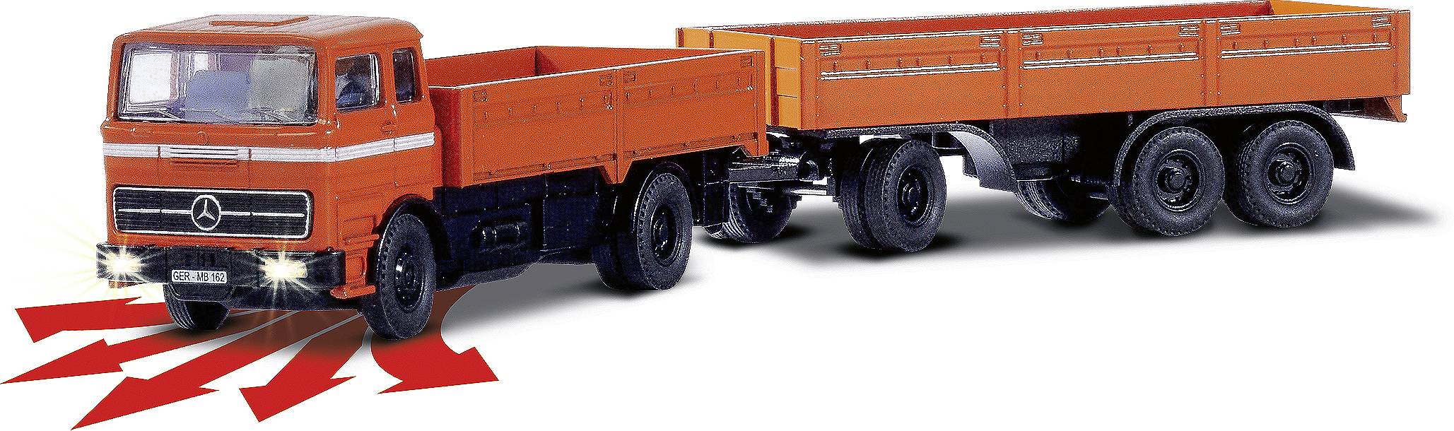 Pomarańczowa ciężarówka z przyczepą skręcająca w jednym kierunku. Czerwone strzałki wskazują kierunek skrętu i jazdy.