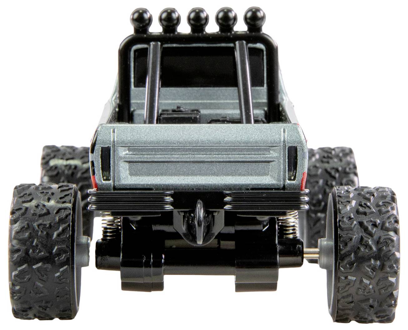 Zabawkowy monster truck widziany od tyłu, z dużymi, grubymi oponami i szarą karoserią, gotowy do przygód terenowych.